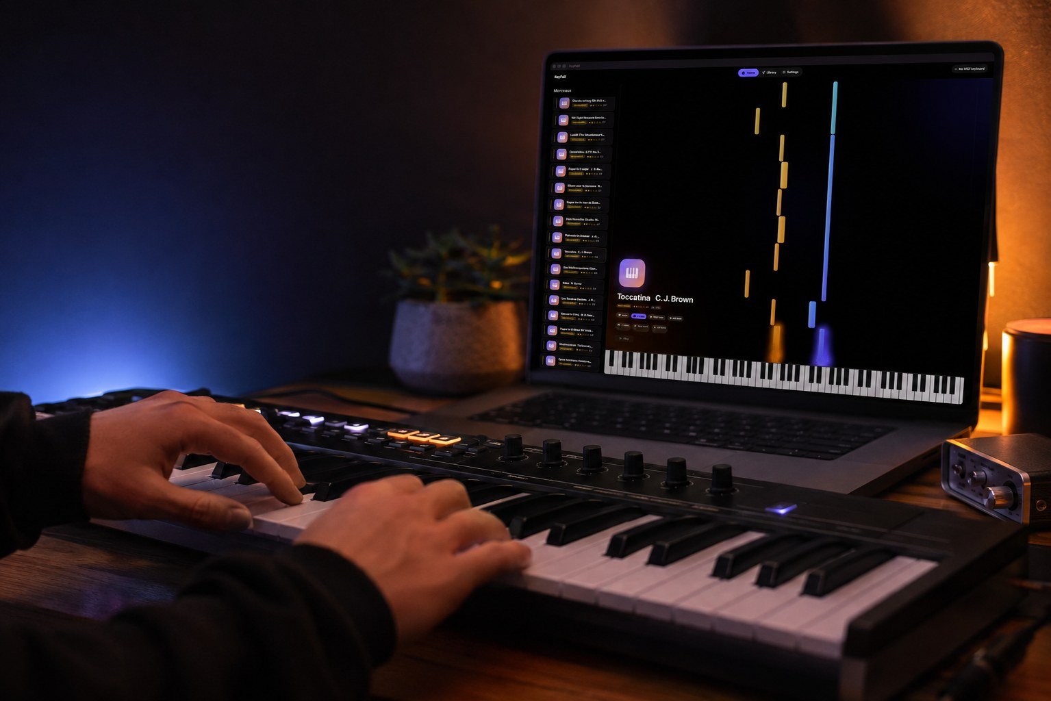 Someone playing piano on their MIDI keyboard, KeyFall showing on their Mac